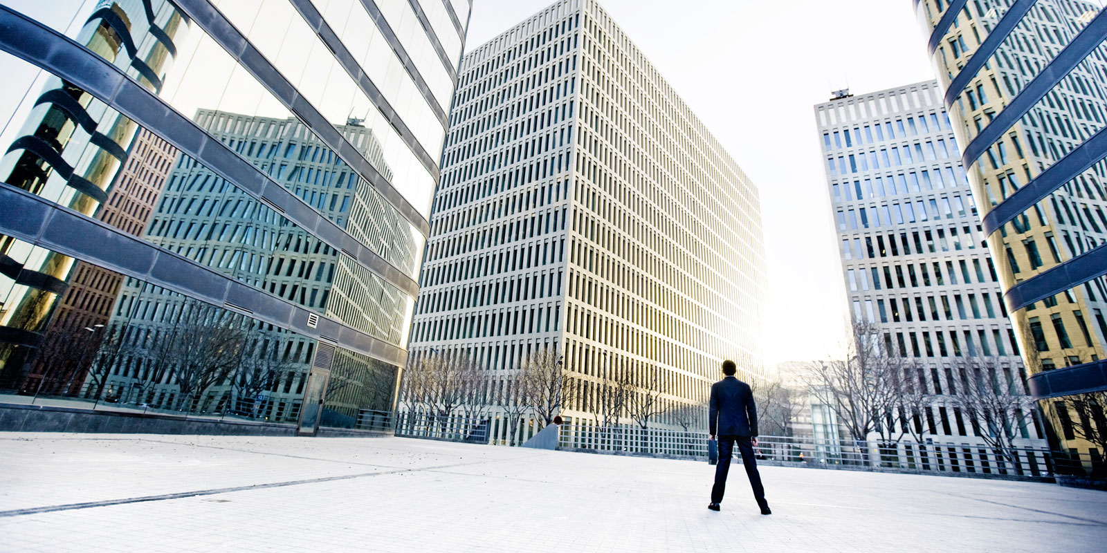 man standing in front of commercial buildings